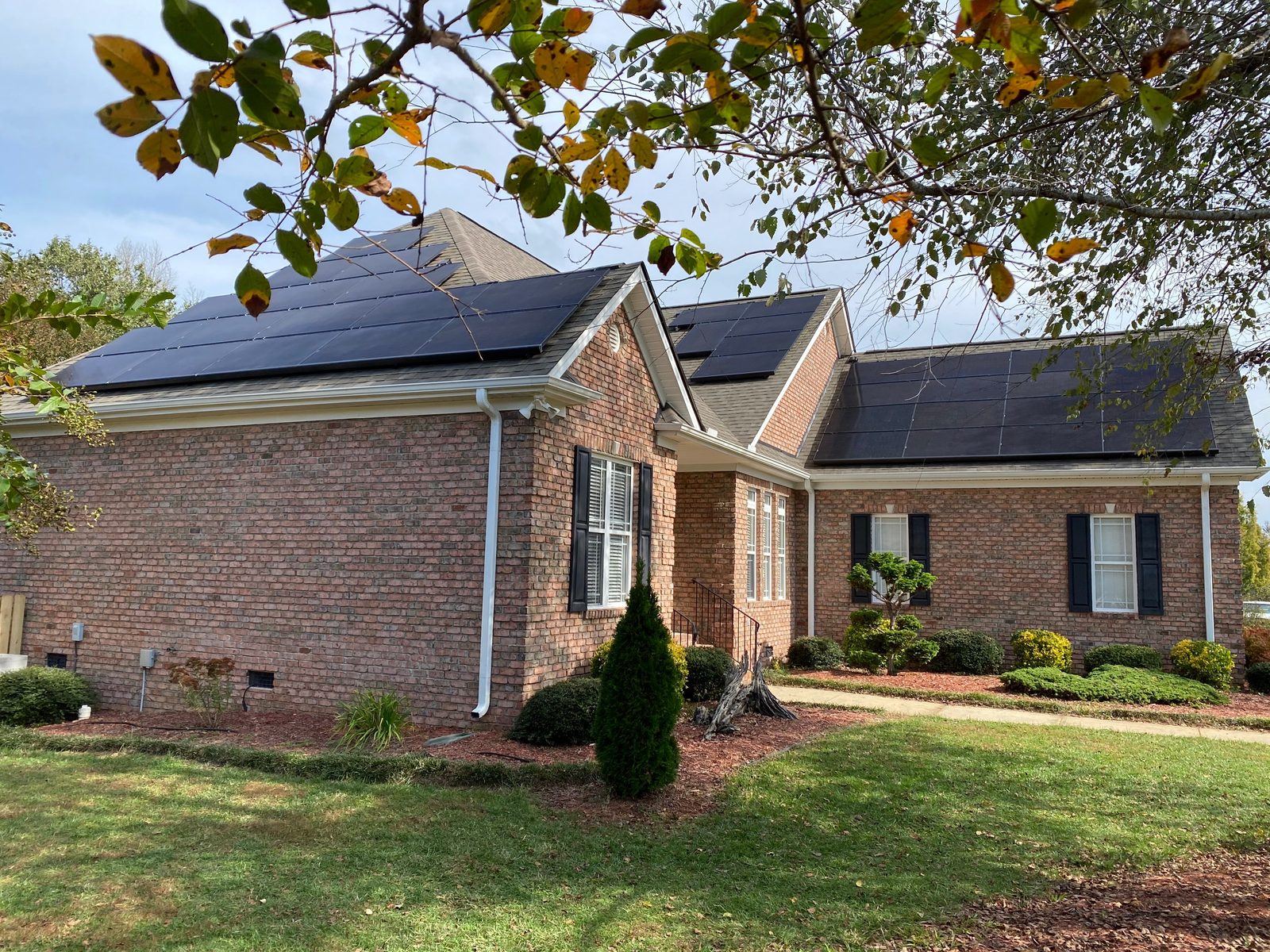 Solar panel installation across multiple roof planes on a brick home in the Raleigh Triangle NC